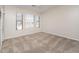 A vacant bedroom offers a large window providing natural light and carpeted floors at 3131 E Legacy Dr # 2101, Phoenix, AZ 85042