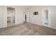 A bright bedroom with carpeted floors and a door leading to the outside at 3131 E Legacy Dr # 2101, Phoenix, AZ 85042