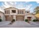 Inviting two-story townhome featuring a private balcony and attached two-car garage, set against a backdrop of a blue, cloudy sky at 3131 E Legacy Dr # 2101, Phoenix, AZ 85042