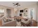 Bright living room featuring a fireplace, built-in shelving, an entertainment center, and elegant archways that lead to other rooms at 3131 E Legacy Dr # 2101, Phoenix, AZ 85042