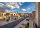 Street view of townhomes with a manicured landscape and sidewalks on either side at 3131 E Legacy Dr # 2101, Phoenix, AZ 85042