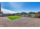 Low maintenance backyard with artificial turf patch and desert landscaping at 31400 N 130Th Ave, Peoria, AZ 85383