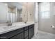 Bright bathroom featuring a double sink vanity, a large mirror, and modern fixtures at 31400 N 130Th Ave, Peoria, AZ 85383