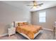 Neutral bedroom with a ceiling fan, large window, and a queen size bed with bedside tables at 31400 N 130Th Ave, Peoria, AZ 85383