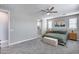 Bright, airy bedroom featuring neutral walls, a ceiling fan and comfortable carpeting at 31400 N 130Th Ave, Peoria, AZ 85383