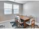 Well-lit dining room with a large wooden table and chairs on top of a modern patterned rug at 31400 N 130Th Ave, Peoria, AZ 85383