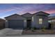 Charming single-story home showcasing a neutral color palette and low-maintenance desert landscaping at 31400 N 130Th Ave, Peoria, AZ 85383