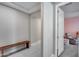 Hallway with neutral colors and a wooden storage bench at 31400 N 130Th Ave, Peoria, AZ 85383