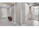 Hallway with tile flooring and neutral walls, with the front door and a small bench seat at 31400 N 130Th Ave, Peoria, AZ 85383