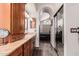 Bright bathroom featuring granite counters, cabinets, and an arched doorway leading to the main bedroom at 3238 E Ashurst Dr, Phoenix, AZ 85048