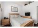 Well-lit bedroom with a wood-frame bed and matching furniture at 3238 E Ashurst Dr, Phoenix, AZ 85048