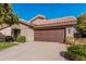 Home featuring desert landscaping, a tile roof, and an attached two-car garage at 3238 E Ashurst Dr, Phoenix, AZ 85048