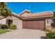 Home featuring desert landscaping, a tile roof, and an attached two-car garage at 3238 E Ashurst Dr, Phoenix, AZ 85048