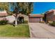 Home featuring desert landscaping, a tile roof, and an attached two-car garage at 3238 E Ashurst Dr, Phoenix, AZ 85048