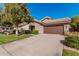 Home featuring desert landscaping, a tile roof, and an attached two-car garage at 3238 E Ashurst Dr, Phoenix, AZ 85048