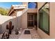 Welcoming front entry with a security door, desert landscaping, and a tiled roof overhang at 3238 E Ashurst Dr, Phoenix, AZ 85048