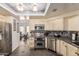 Well-lit kitchen featuring stainless steel appliances and mosaic tile backsplash at 3238 E Ashurst Dr, Phoenix, AZ 85048