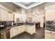 Open kitchen area with tile backsplash, light wood cabinets, and views of the dining area at 3238 E Ashurst Dr, Phoenix, AZ 85048