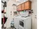 Efficient laundry room with washer, dryer, storage cabinets, and convenient overhead shelving at 3238 E Ashurst Dr, Phoenix, AZ 85048