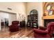 Inviting living room with hardwood floors, fireplace, ceiling fan, and comfortable seating at 3238 E Ashurst Dr, Phoenix, AZ 85048