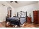 Main bedroom featuring wood floors, ceiling fan and an arched doorway at 3238 E Ashurst Dr, Phoenix, AZ 85048