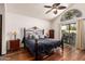 Main bedroom featuring wood floors, ceiling fan and sliding doors to yard at 3238 E Ashurst Dr, Phoenix, AZ 85048