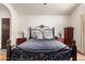 Main bedroom with wood floors, ceiling fan and matching nightstands at 3238 E Ashurst Dr, Phoenix, AZ 85048