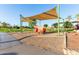 Community playground featuring a covered play area with toy firetruck, sand and other play equipment at 3238 E Ashurst Dr, Phoenix, AZ 85048