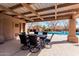 A covered outdoor dining area overlooks the community pool in this inviting space at 3238 E Ashurst Dr, Phoenix, AZ 85048