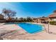 Community pool is highlighted by a clear, blue sky in this daytime shot at 3238 E Ashurst Dr, Phoenix, AZ 85048