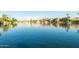 A tranquil lake view reflects the surrounding homes and palm trees at 3238 E Ashurst Dr, Phoenix, AZ 85048