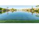 Beautiful water view of a calm lake with a fountain and surrounding homes at 3238 E Ashurst Dr, Phoenix, AZ 85048