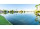 A scenic view of a lake with lush green grass in the foreground at 3238 E Ashurst Dr, Phoenix, AZ 85048