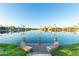 Peaceful waterfront view featuring a tranquil lake and luxurious homes, complemented by manicured landscaping at 3238 E Ashurst Dr, Phoenix, AZ 85048