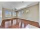 Spacious bedroom featuring hardwood floors, plantation shutters, and ceiling fan at 34014 N 43Rd St, Cave Creek, AZ 85331