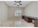 Clean bedroom features tile floors, plantation shutters and a wooden desk at 34014 N 43Rd St, Cave Creek, AZ 85331