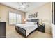 This bedroom has a ceiling fan, plantation shutters, and a view of the backyard at 34014 N 43Rd St, Cave Creek, AZ 85331