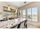 Breakfast bar with sleek pendant lighting and views of the outside patio and desert landscape at 34014 N 43Rd St, Cave Creek, AZ 85331