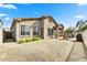 Rear exterior showcasing a covered patio and desert landscaping at 34014 N 43Rd St, Cave Creek, AZ 85331