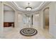 Grand foyer boasts travertine floors, mosaic inlay, tray ceilings, and archways, adding architectural detail at 34014 N 43Rd St, Cave Creek, AZ 85331