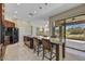 Open kitchen has granite counters, black appliances, and island seating with access to patio at 34014 N 43Rd St, Cave Creek, AZ 85331