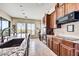 Kitchen with granite counters, modern appliances, and abundant natural light from large windows at 34014 N 43Rd St, Cave Creek, AZ 85331