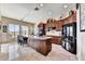 Spacious kitchen with dark wood cabinets, a black refrigerator, and center island with seating at 34014 N 43Rd St, Cave Creek, AZ 85331