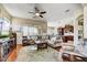 Open concept living room with hardwood floors, a ceiling fan, and a view into the kitchen at 34014 N 43Rd St, Cave Creek, AZ 85331