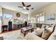 Comfortable living room features wood floors, neutral walls, ceiling fan, and view to outside at 34014 N 43Rd St, Cave Creek, AZ 85331