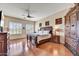 The main bedroom features wood floors, a ceiling fan, and plenty of natural light at 34014 N 43Rd St, Cave Creek, AZ 85331