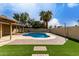 Expansive backyard featuring a pool, patio, and lush artificial turf at 3503 E Campo Bello Dr, Phoenix, AZ 85032