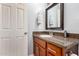 Bathroom vanity featuring granite countertops and wood cabinetry at 3503 E Campo Bello Dr, Phoenix, AZ 85032