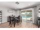 Dining space with view to pool, includes bar area, and natural light from the sliding glass door at 3503 E Campo Bello Dr, Phoenix, AZ 85032