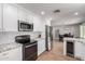 Modern kitchen with white cabinets, stainless steel appliances, and granite countertops at 3503 E Campo Bello Dr, Phoenix, AZ 85032